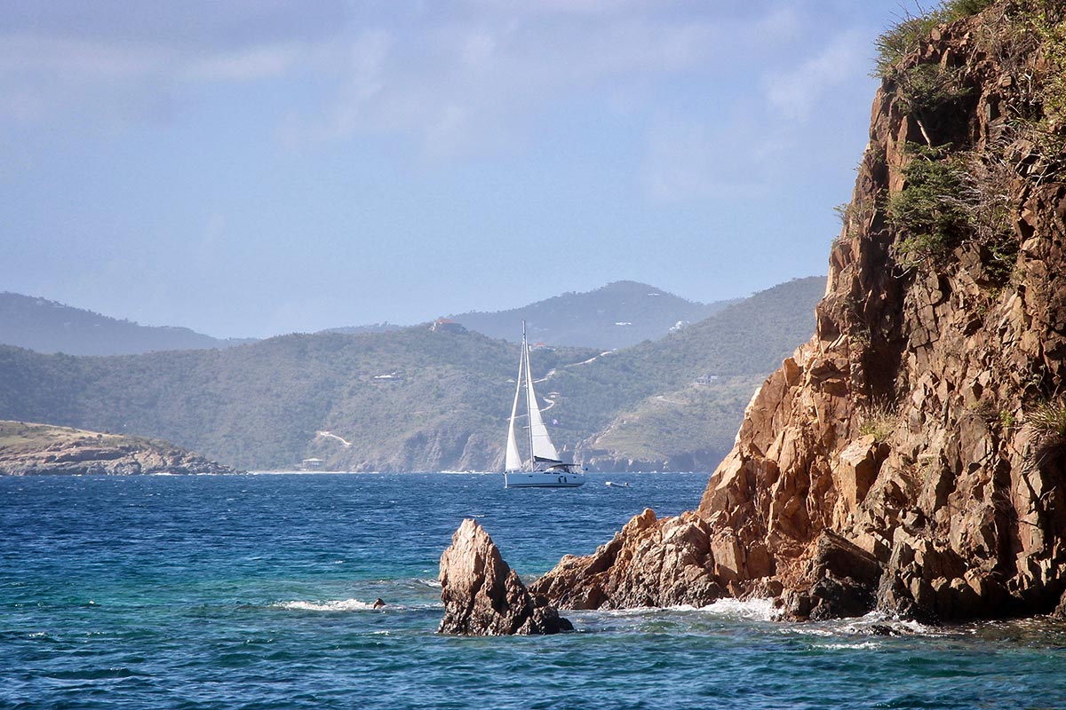 a sailboat sailing by Norman Island